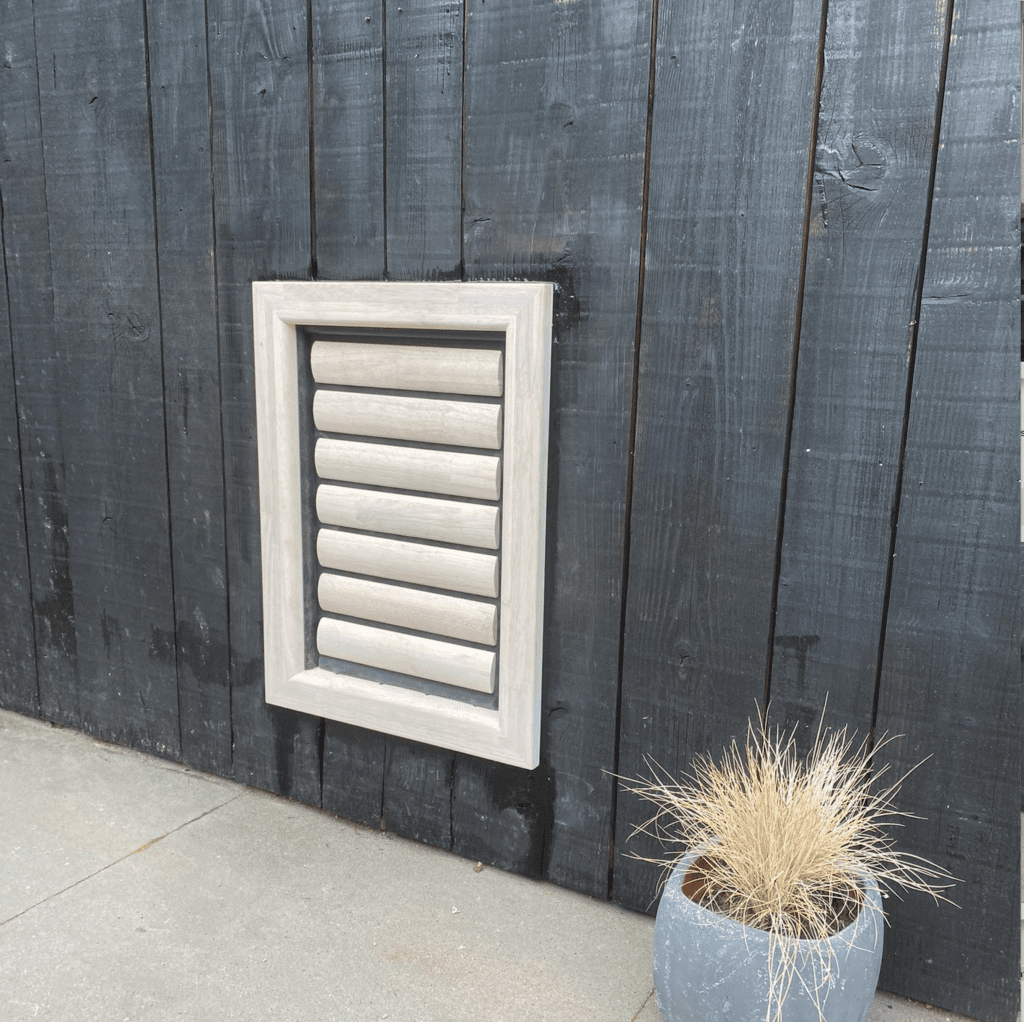 a draft-free large wooden dog door for a large dog such as a labrador or greyhound installed burglar-proof by Tomsgates in a black-painted wooden wall